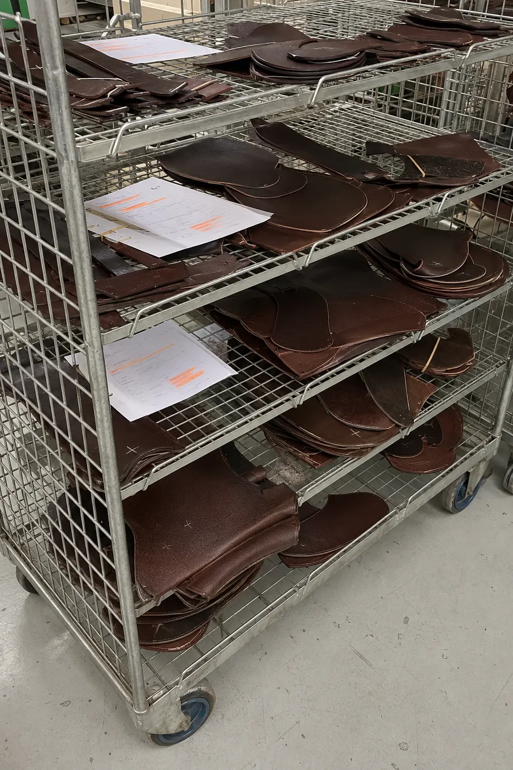 Cut saddle components organized on a production rack