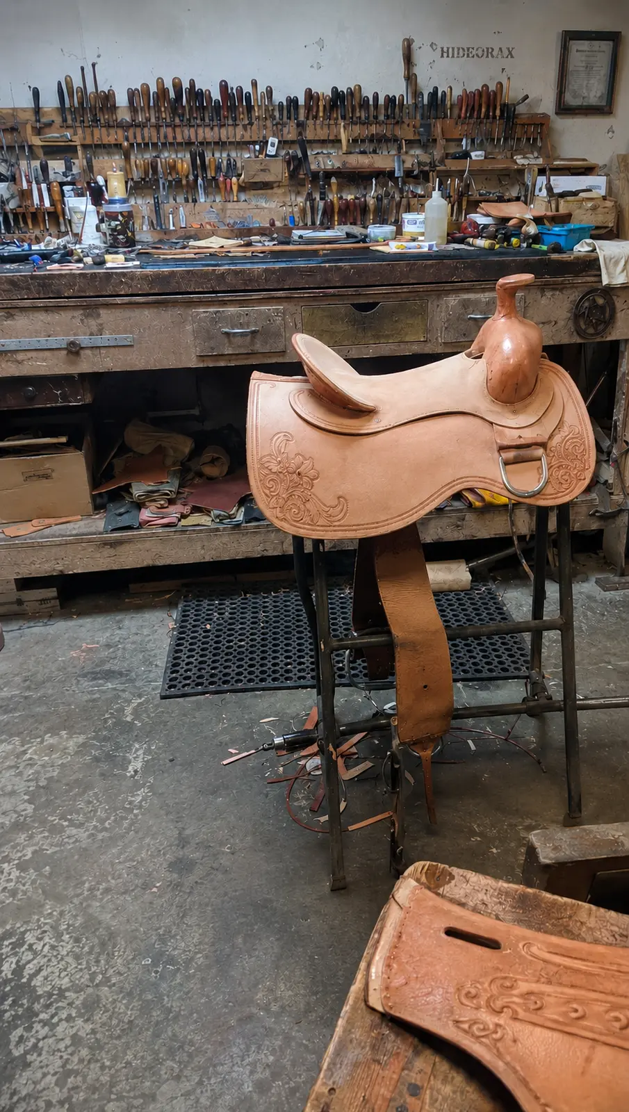 Western saddle inspection in a saddlery workshop